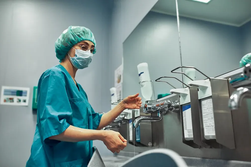 Health Regulations Doctor Washes Before Surgery